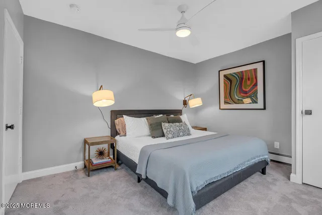 a bedroom with a bed and a lamp on table