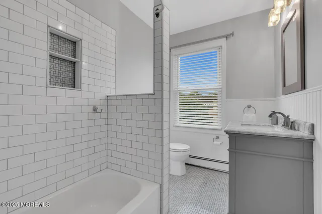 a bathroom with a sink a toilet and tub