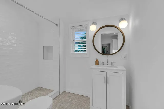 a bathroom with a toilet a sink and a mirror