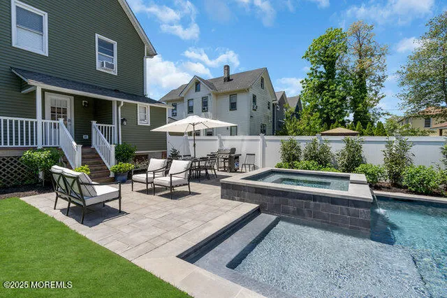 a view of a patio with couches table and chairs potted plants and a large tree