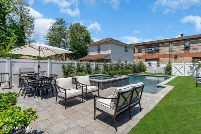 a backyard of a house with table and chairs