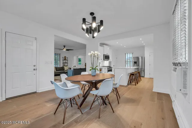 a view of a dining room with furniture and chandelier