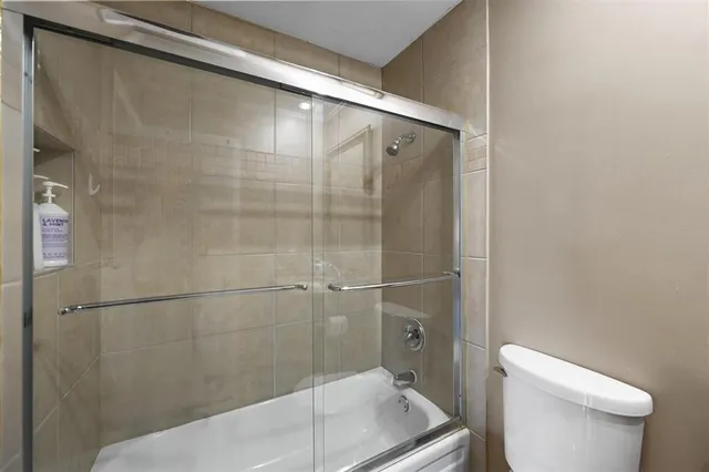 a bathroom with a shower and toilet