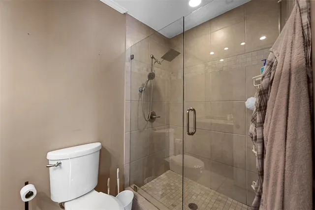 a bathroom with a toilet and a shower