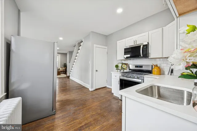 a kitchen with a refrigerator stove and microwave