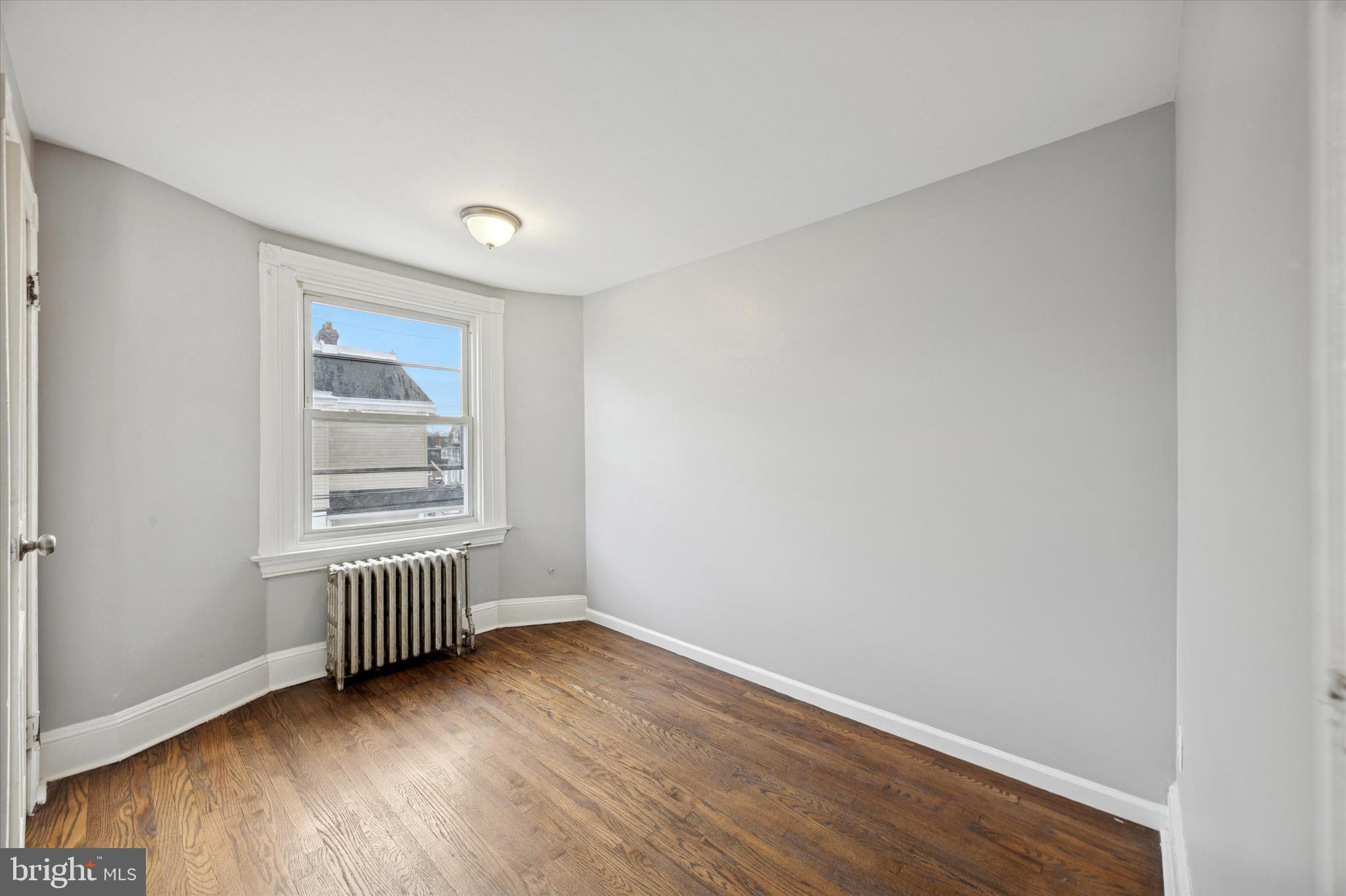 105 Nyack Avenue Lansdowne, PA 19050 - Photo 24 of 29 an empty room with wooden floor and windows