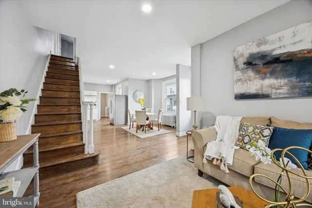 a living room with furniture and wooden floor