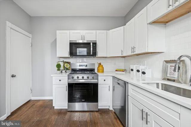 a kitchen with a stove top oven and cabinets