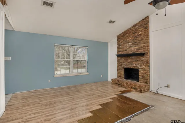 a view of empty room with fireplace