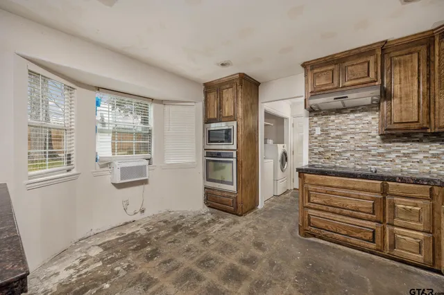 a view of cabinets and window in an empty room
