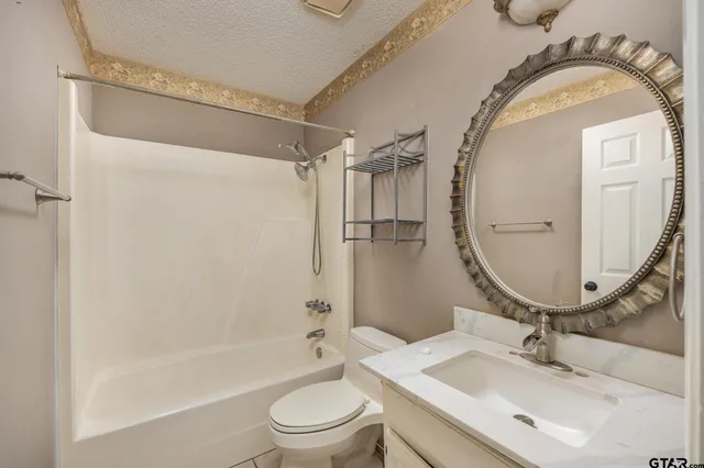 a bathroom with a sink mirror toilet and bathtub