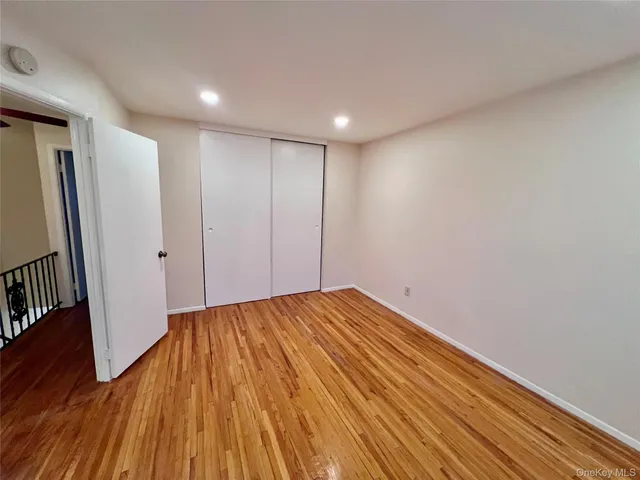 a view of hallway with wooden floor