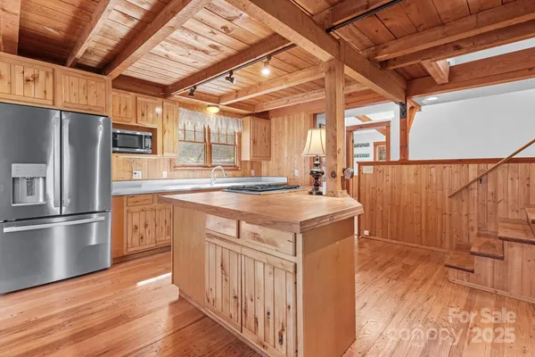 a kitchen with a sink appliances and cabinets