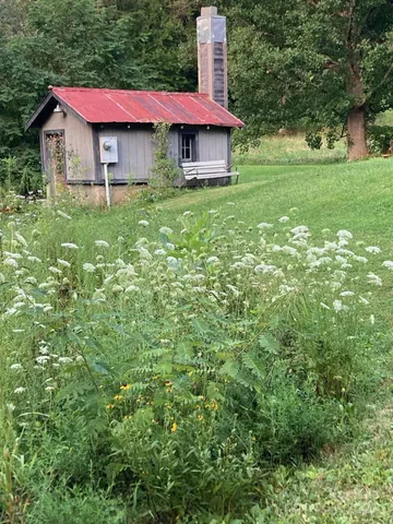 a sign that is sitting in front of flowers