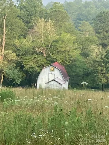 a view of a house with a wooden fence