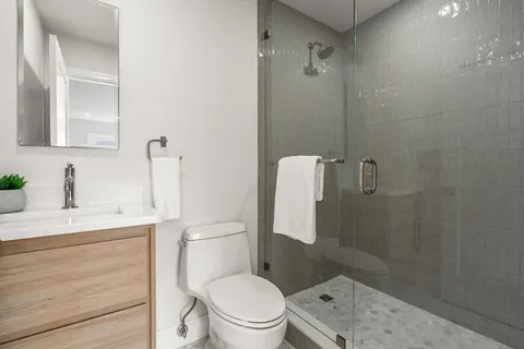 a white toilet sitting next to a bathroom sink