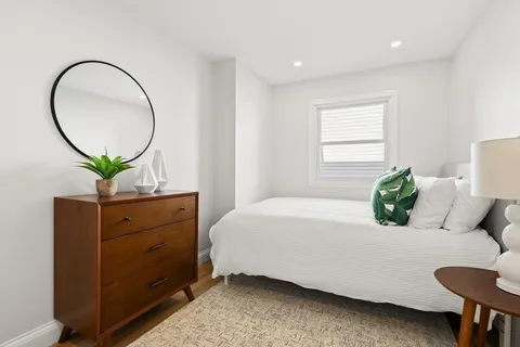 a bedroom with a bed and a dresser