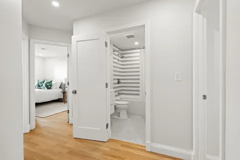a view of a hallway to a livingroom and a hallway