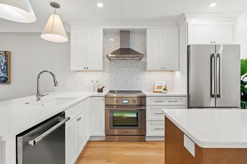 a kitchen with a sink stove and refrigerator