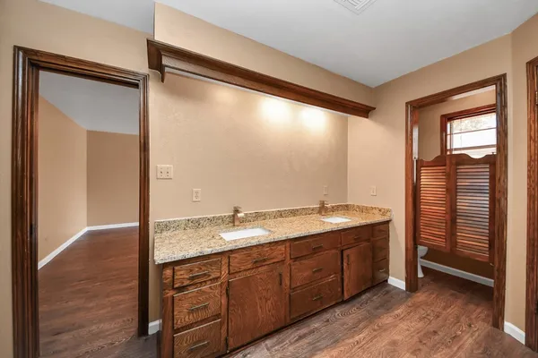 a bathroom with a granite countertop sink mirror and double