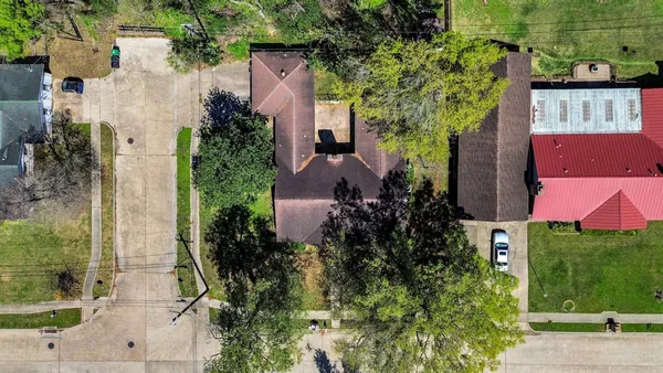 an aerial view of a house with a yard and garden