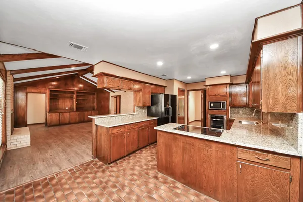 a kitchen with granite countertop a sink and cabinets