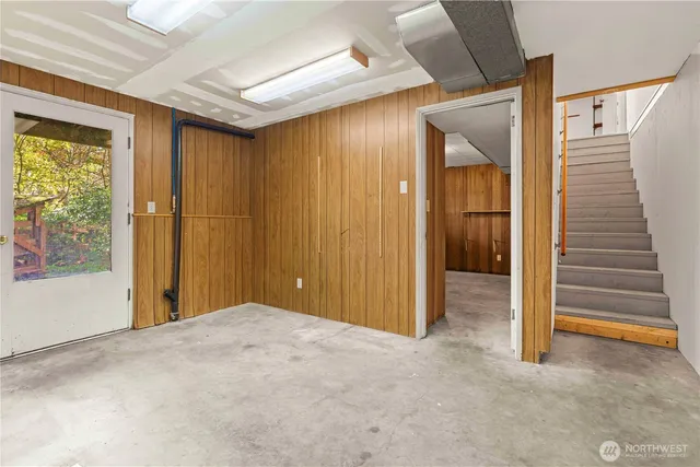 a view of a livingroom with entryway and stairs