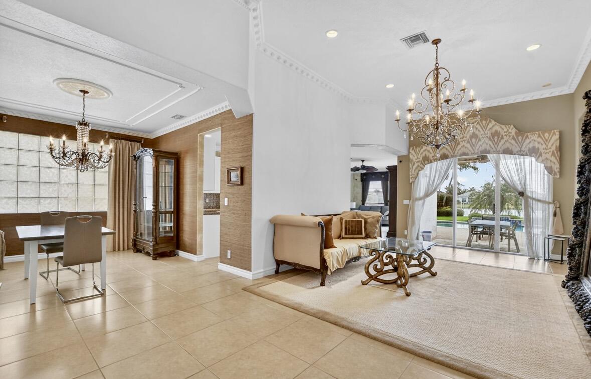 7879 Monarch Court Delray Beach, FL 33446 - Photo 12 of 74 a living room with furniture and a chandelier