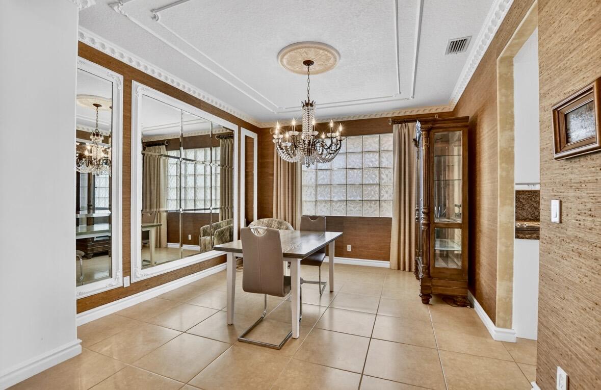 7879 Monarch Court Delray Beach, FL 33446 - Photo 13 of 74 a view of a dining room with furniture and chandelier