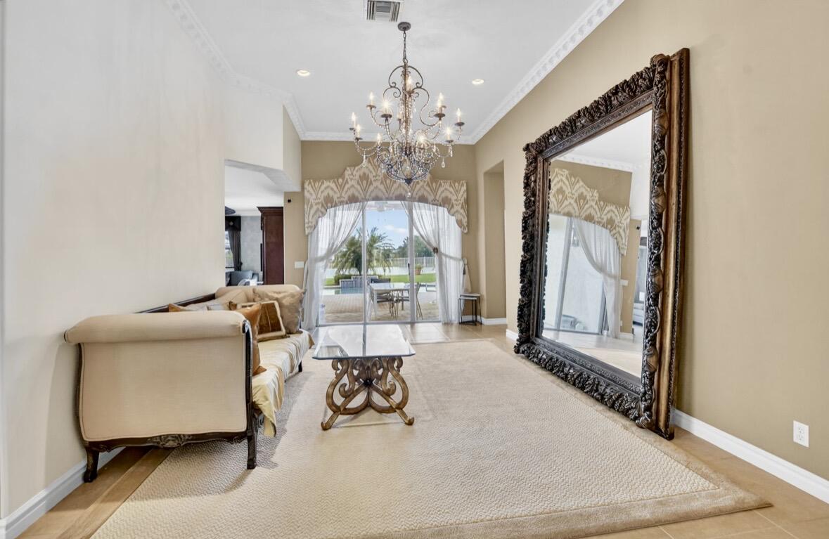 7879 Monarch Court Delray Beach, FL 33446 - Photo 17 of 74 a living room with furniture and a chandelier
