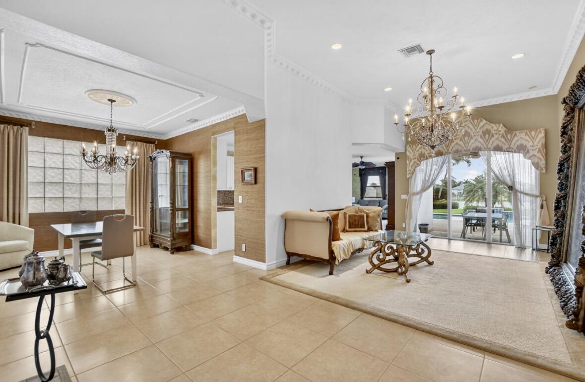 7879 Monarch Court Delray Beach, FL 33446 - Photo 21 of 74 a living room with furniture and a chandelier