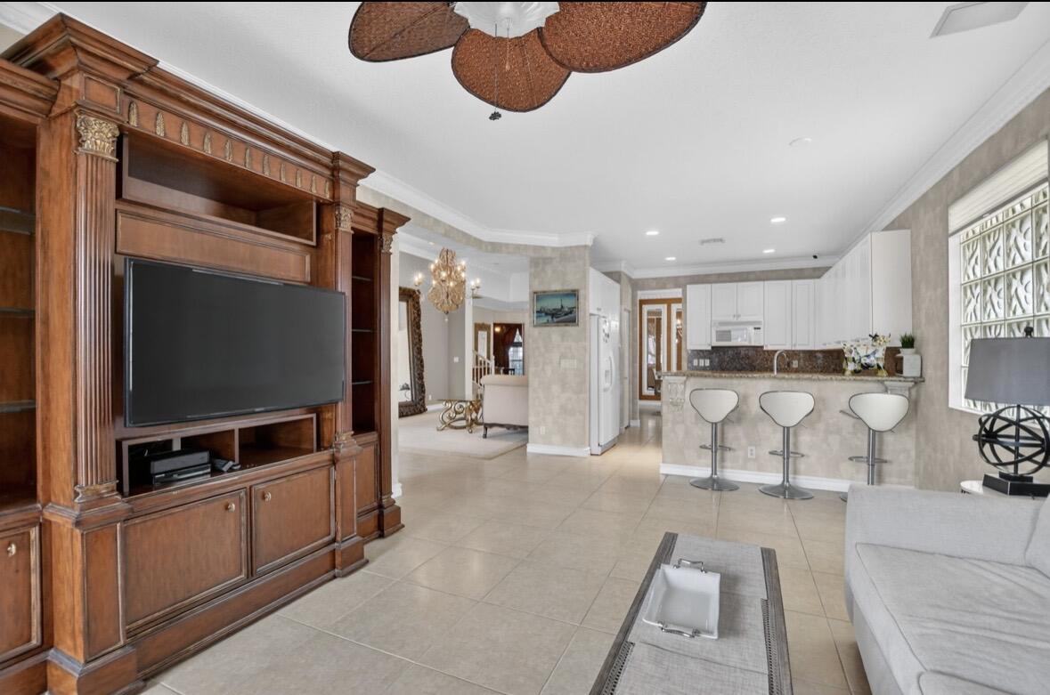 7879 Monarch Court Delray Beach, FL 33446 - Photo 23 of 74 a living room with furniture and a flat screen tv