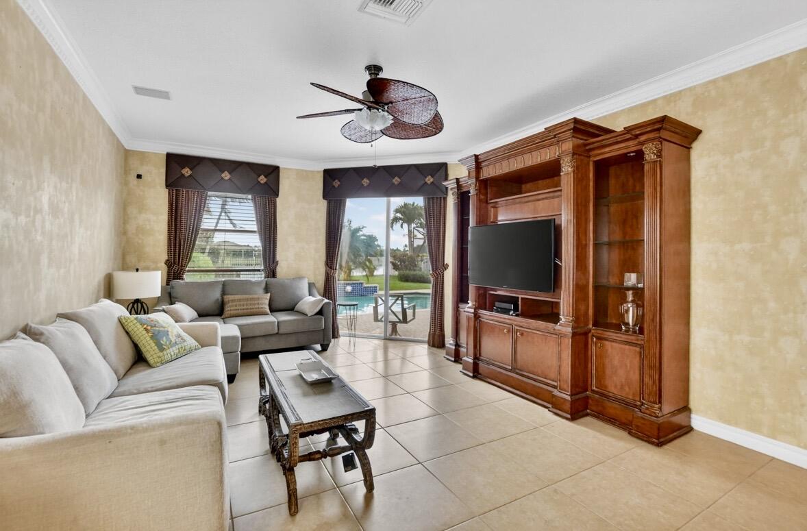 7879 Monarch Court Delray Beach, FL 33446 - Photo 24 of 74 a living room with furniture a flat screen tv and a window
