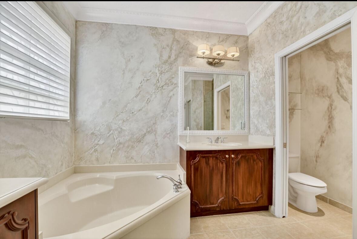 7879 Monarch Court Delray Beach, FL 33446 - Photo 34 of 74 a bathroom with a sink a toilet and a bathtub