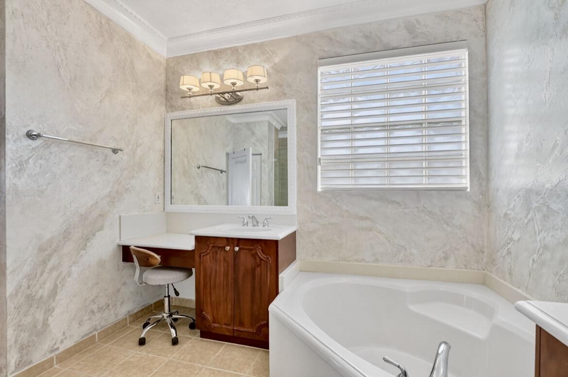 7879 Monarch Court Delray Beach, FL 33446 - Photo 35 of 74 a bathroom with a tub a sink and a window