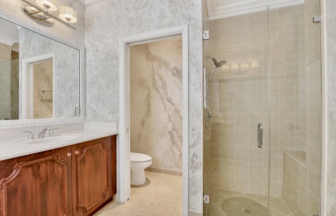 7879 Monarch Court Delray Beach, FL 33446 - Photo 37 of 74 a bathroom with a granite countertop sink toilet and shower