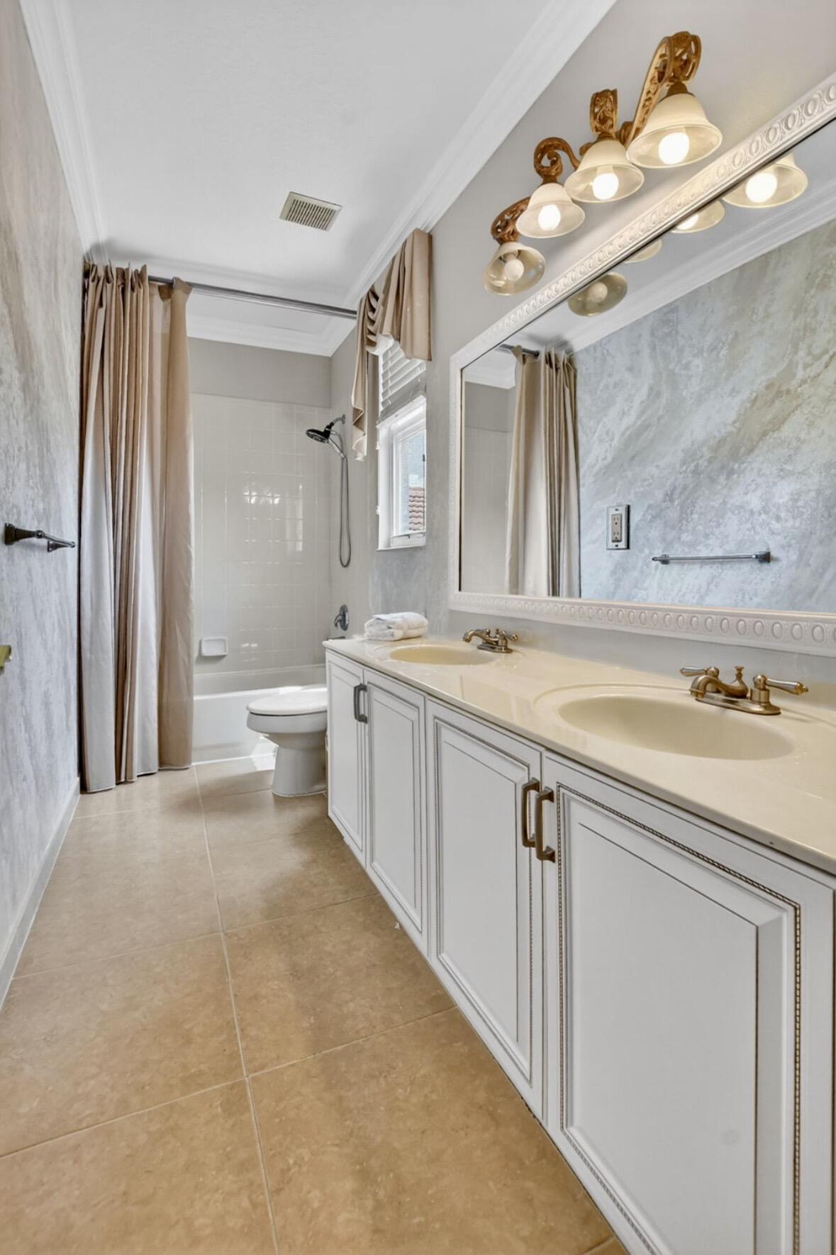 7879 Monarch Court Delray Beach, FL 33446 - Photo 42 of 74 a spacious bathroom with a double vanity sink mirror and toilet