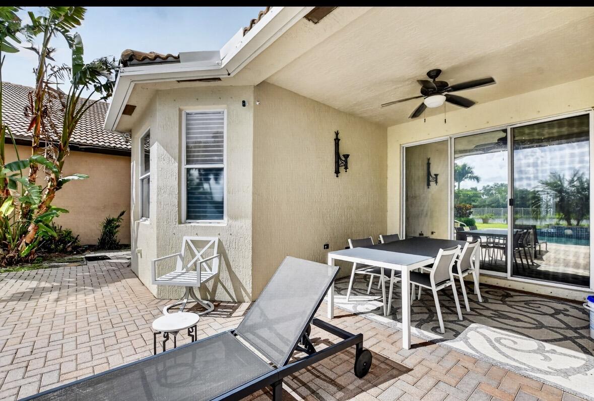 7879 Monarch Court Delray Beach, FL 33446 - Photo 46 of 74 a view of a patio with table and chairs