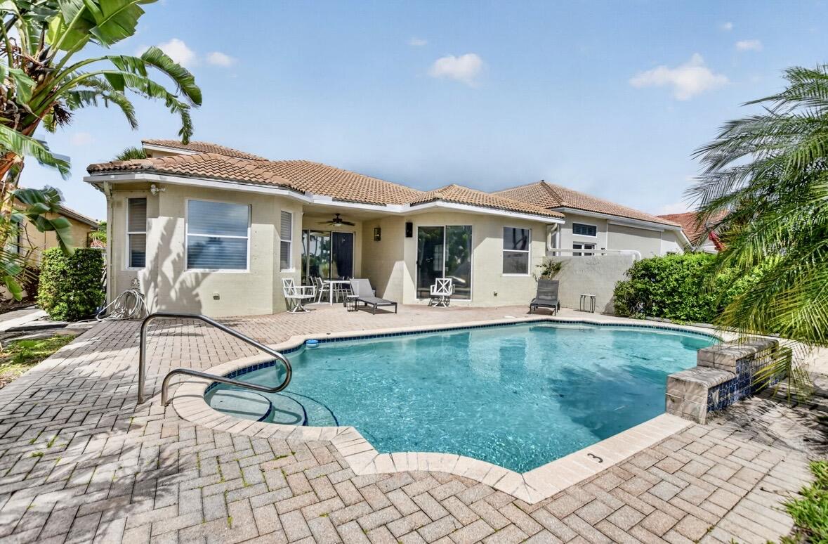 7879 Monarch Court Delray Beach, FL 33446 - Photo 48 of 74 a view of a white house with a yard porch and sitting area
