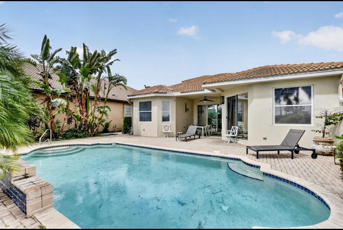7879 Monarch Court Delray Beach, FL 33446 - Photo 49 of 74 a view of a house with swimming pool and sitting area
