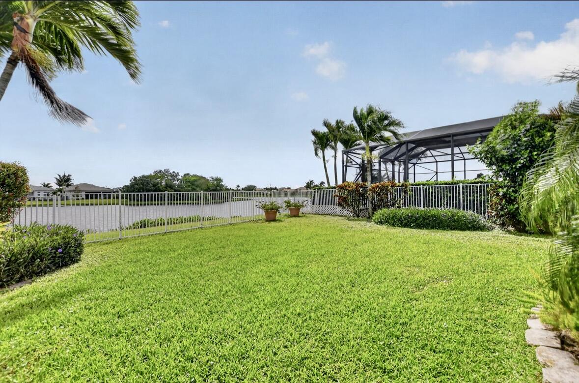 7879 Monarch Court Delray Beach, FL 33446 - Photo 51 of 74 a view of yard with swimming pool and green space