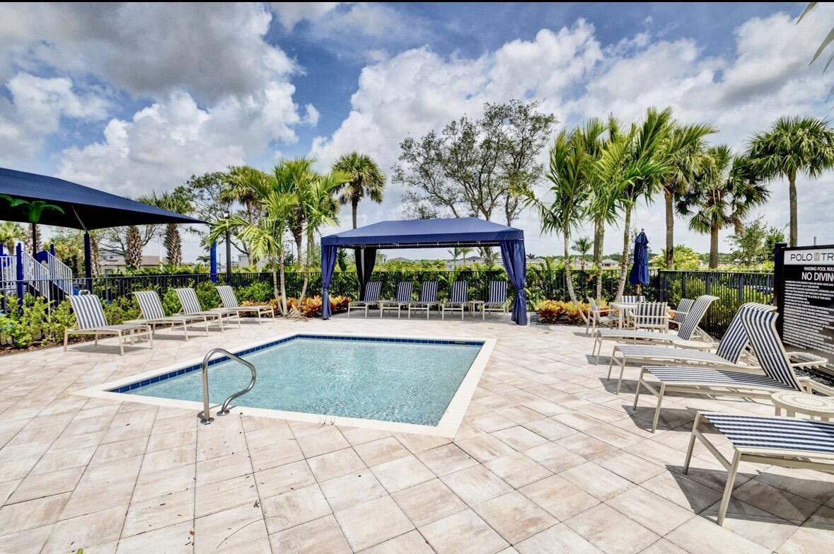 7879 Monarch Court Delray Beach, FL 33446 - Photo 57 of 74 a view of swimming pool with outdoor seating and a patio