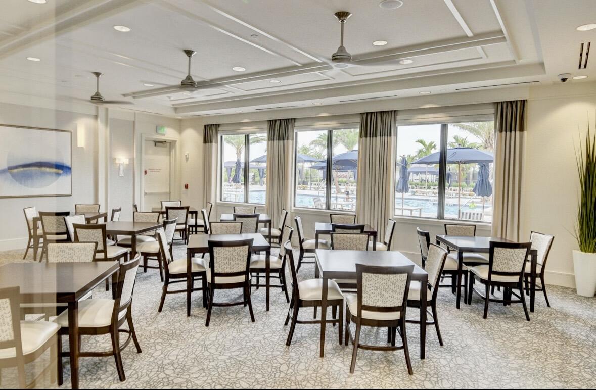 7879 Monarch Court Delray Beach, FL 33446 - Photo 58 of 74 a view of a dining room with furniture and a chandelier