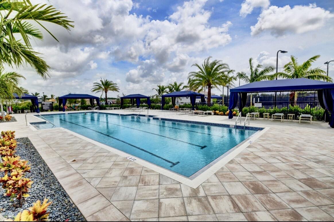 7879 Monarch Court Delray Beach, FL 33446 - Photo 65 of 74 a view of swimming pool with outdoor seating and yard in back