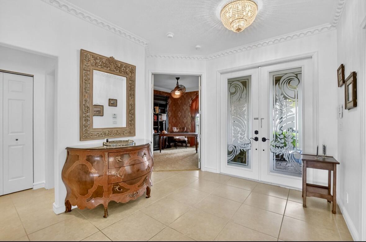 7879 Monarch Court Delray Beach, FL 33446 - Photo 10 of 74 a living room with furniture and a chandelier