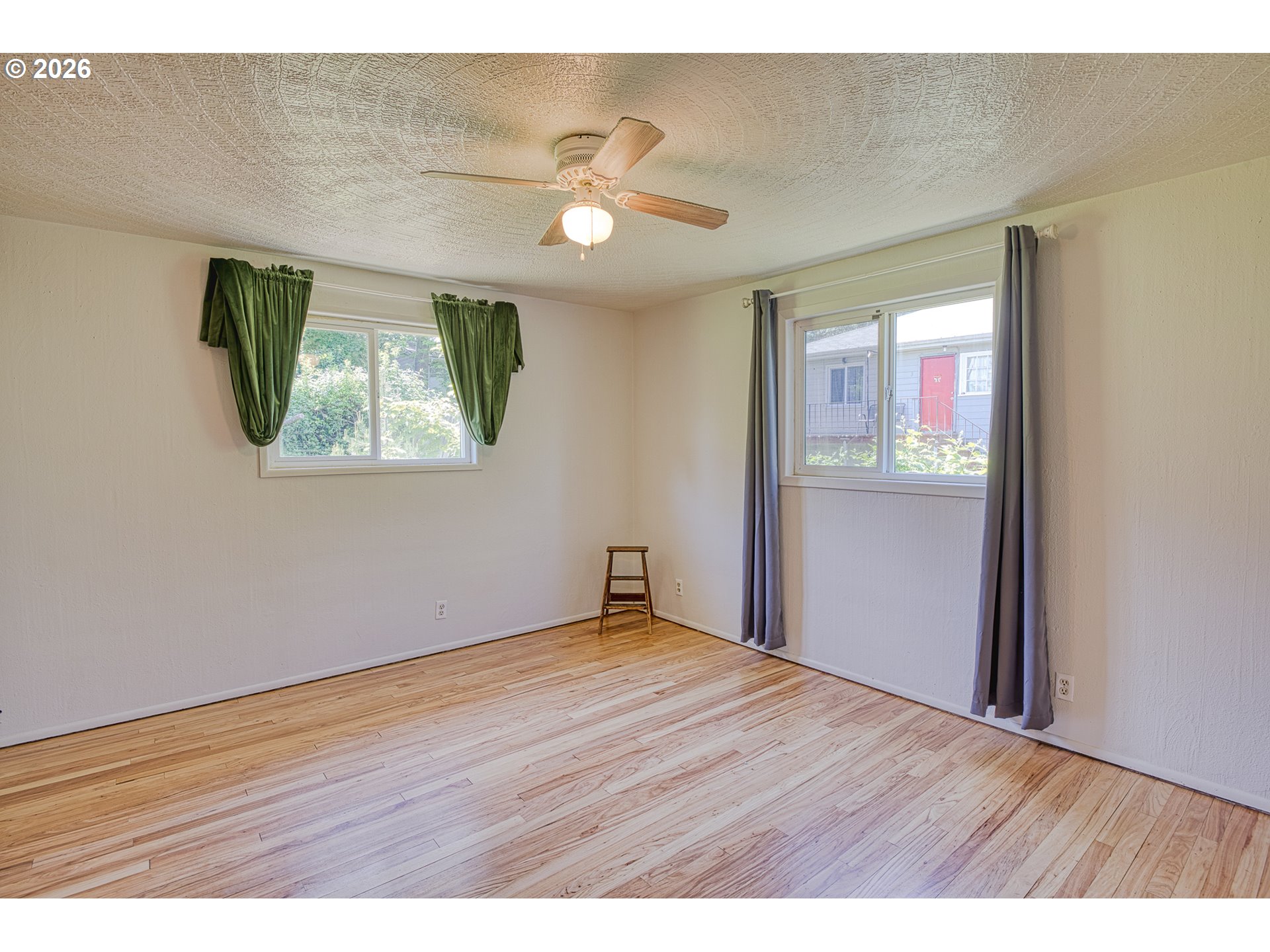 7077 Main Street Springfield, OR 97478 - Photo 16 of 34 a view of an empty room with wooden floor and a window