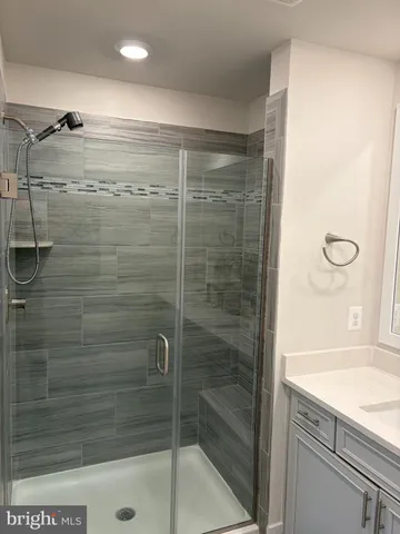 a bathroom with a shower and a sink