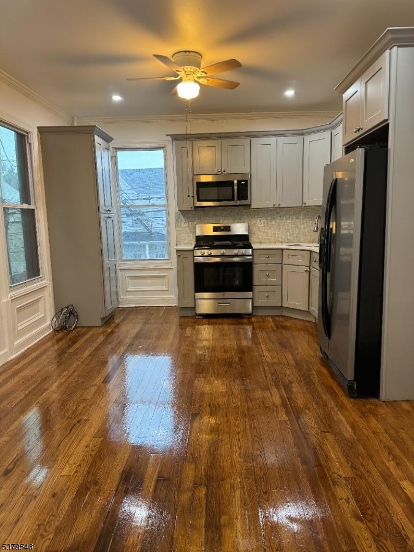 a kitchen with stainless steel appliances a refrigerator a stove top oven a sink and dishwasher