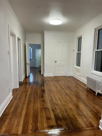 a view of a room with wooden floor and stairs