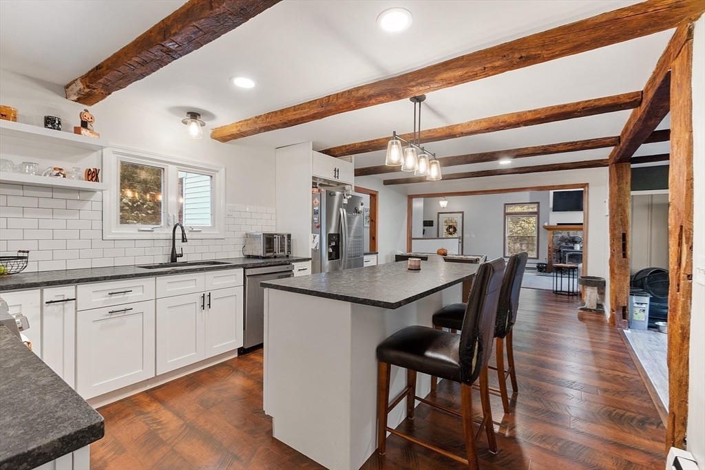 1249 Richardson Road Ashby, MA 01431 - Photo 8 of 31 a kitchen with granite countertop a dining table chairs cabinets wooden floor and appliances